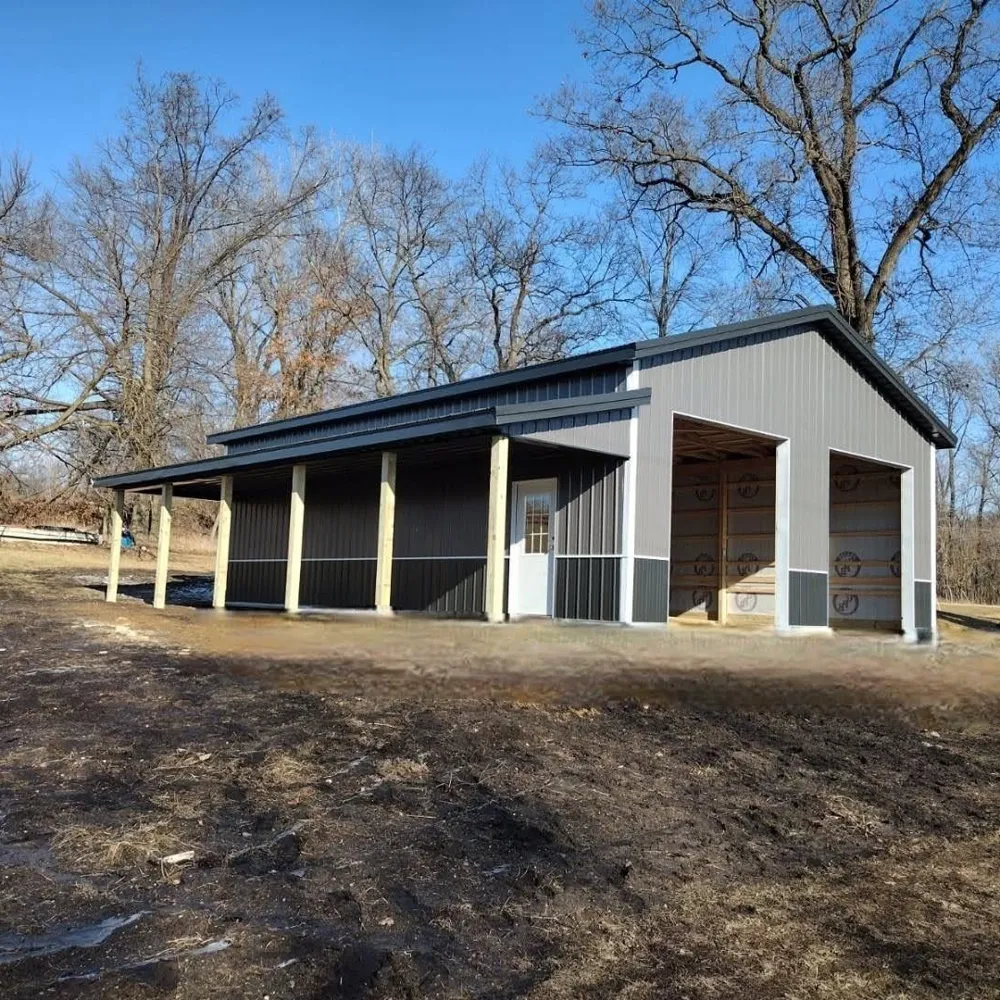 Amish-built white pole barn with overhead garage doors