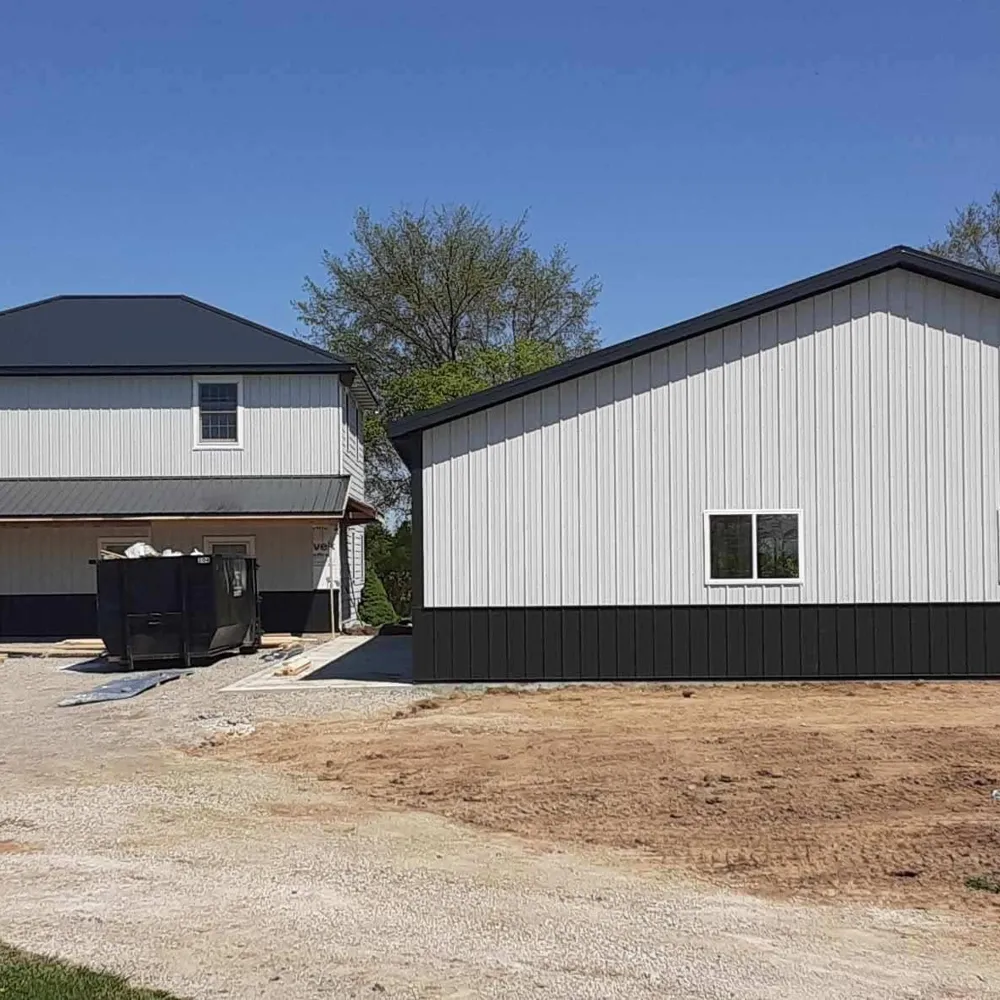 Residential pole barn garage with overhead doors